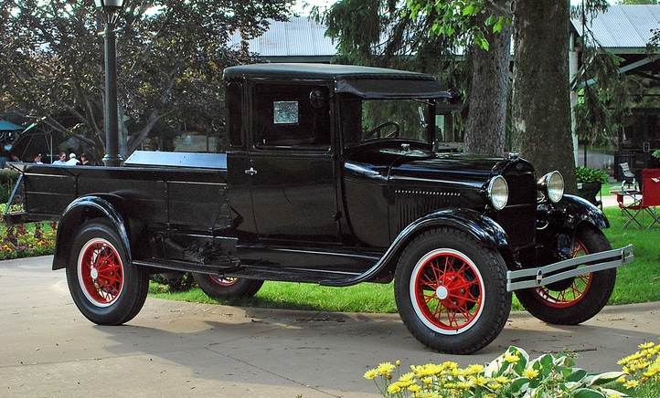 An example of a black truck with red spoke wheels