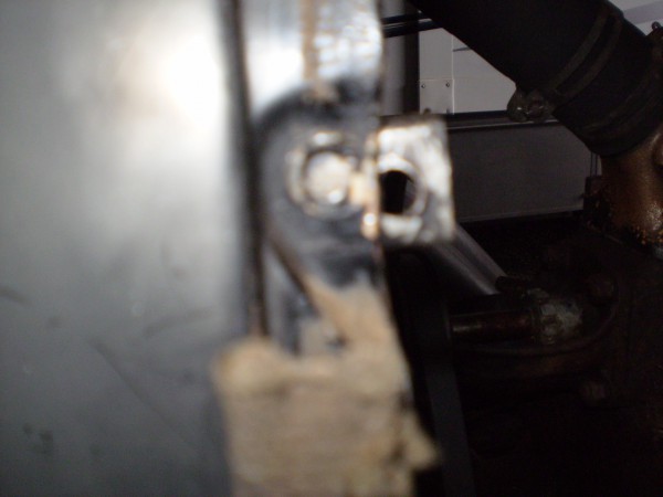 Another view of the mismatch between the mounting bolt holes in the radiator shell and mounting brackets.
